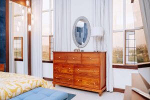 Timbercraft brown wooden chest of drawers, angled-view.