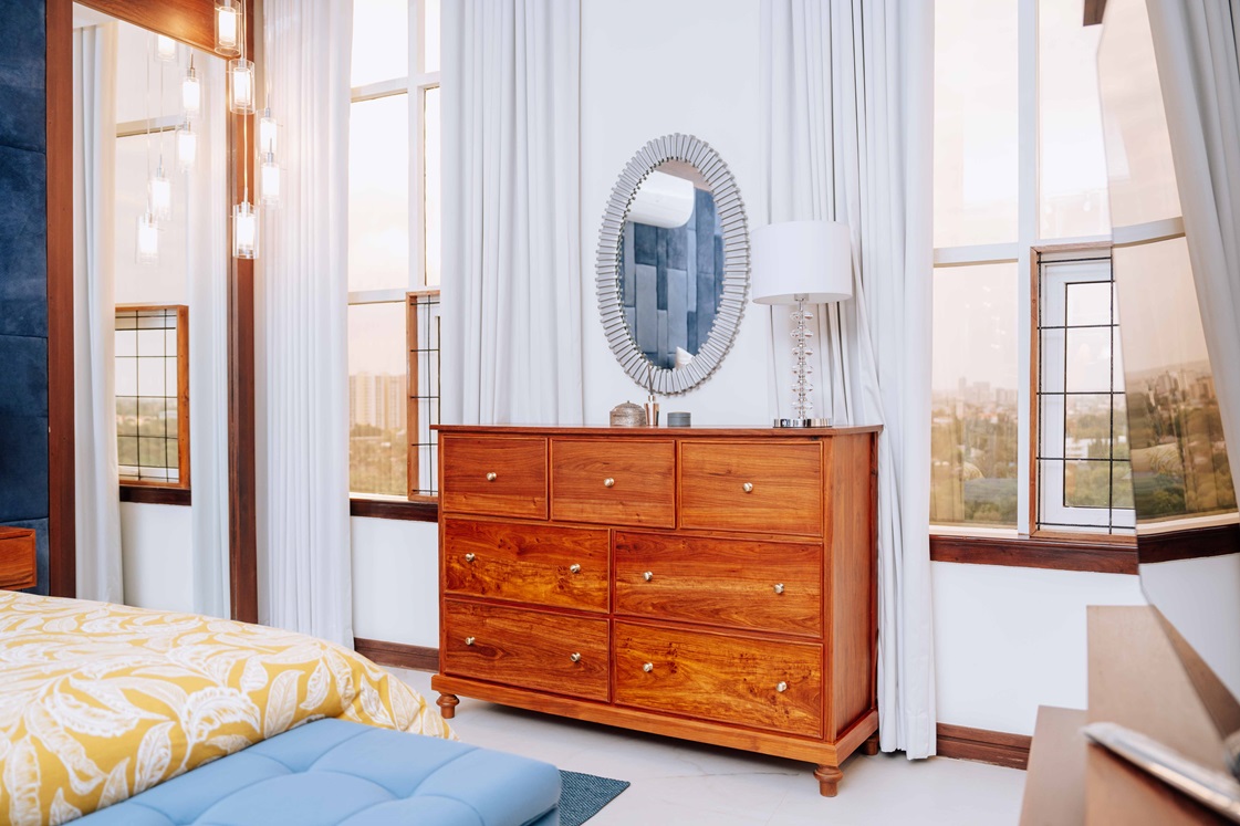 Timbercraft brown wooden chest of drawers, angled-view.
